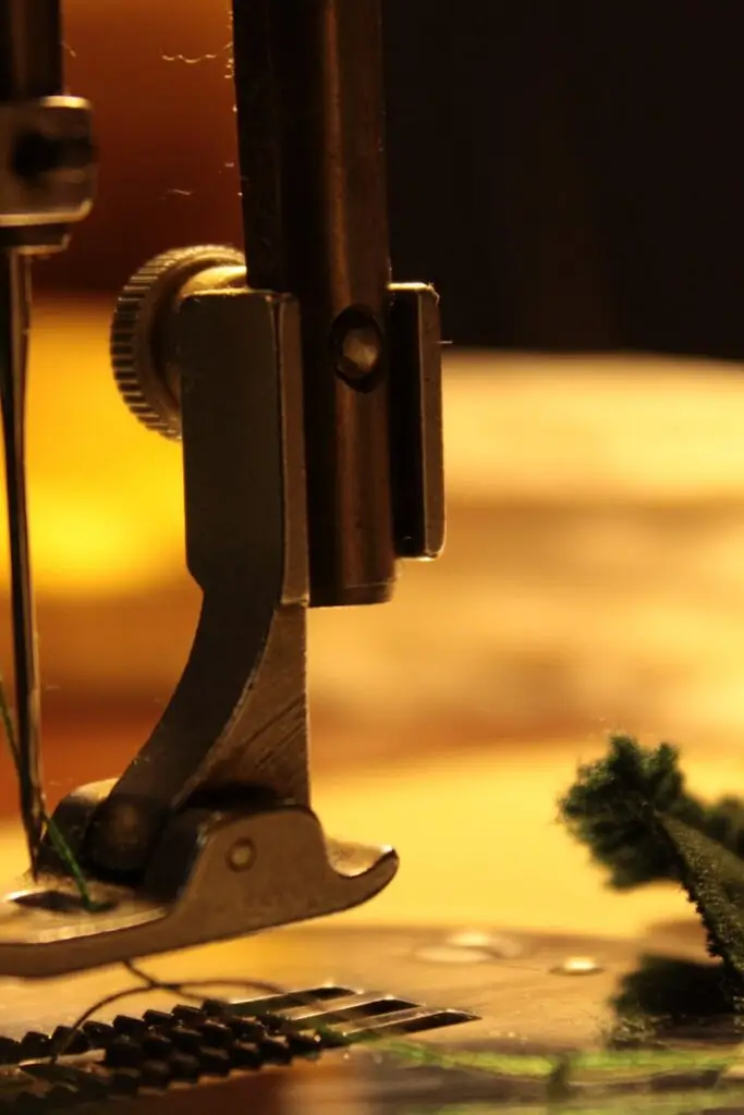 Detailed view of a sewing machine needle stitching fabric, highlighting craftsmanship.